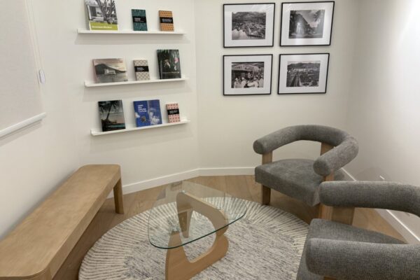 3rd Floor Suite 305 Reception Sitting Area with chairs and books aqnd pictures on the wall