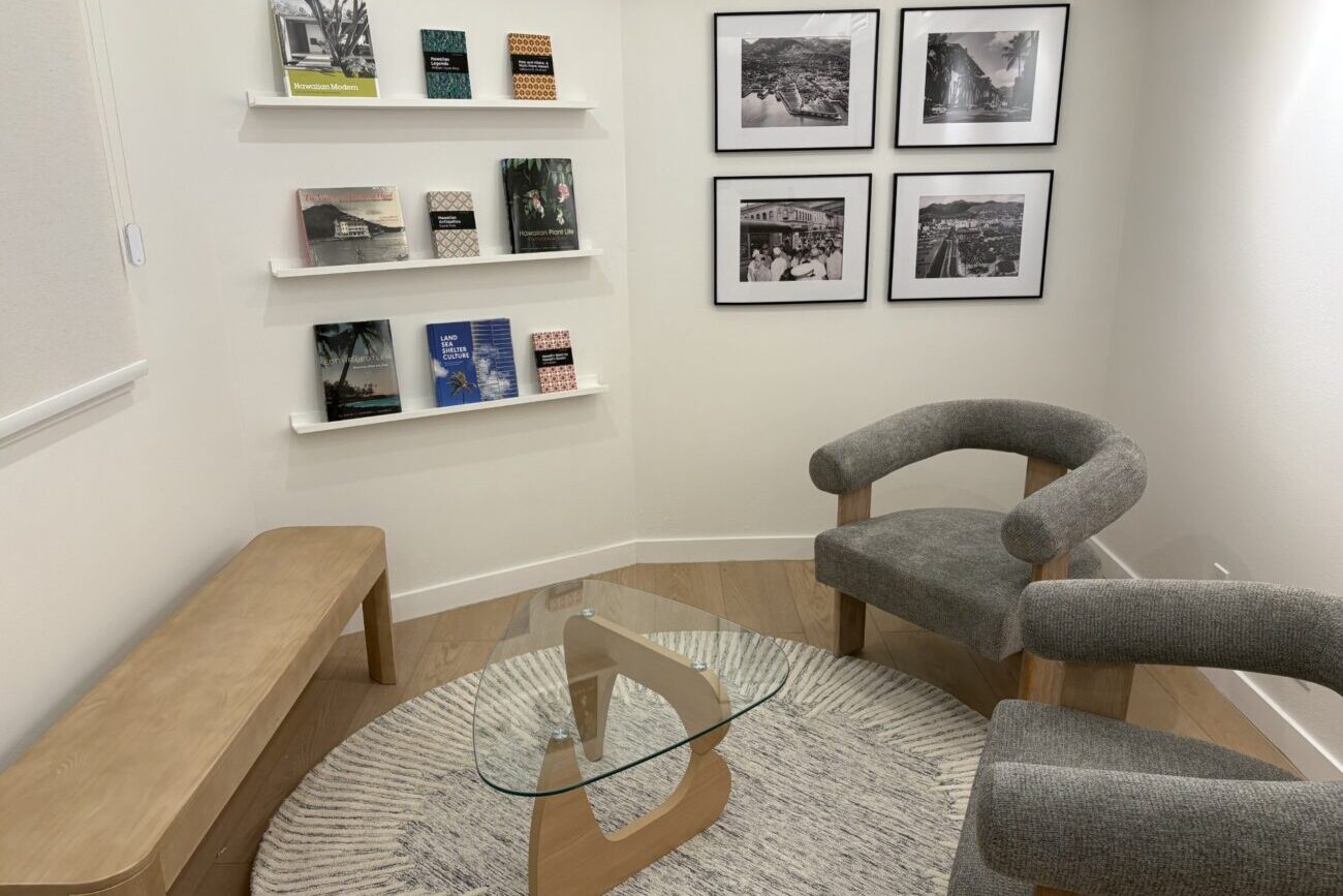 3rd Floor Suite 305 Reception Sitting Area with chairs and books aqnd pictures on the wall