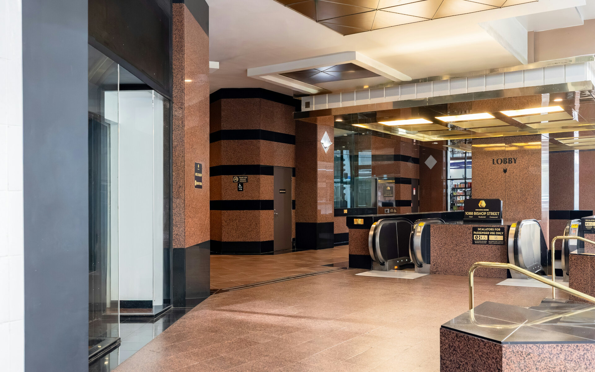 A hotel lobby with an elevator and reception desk