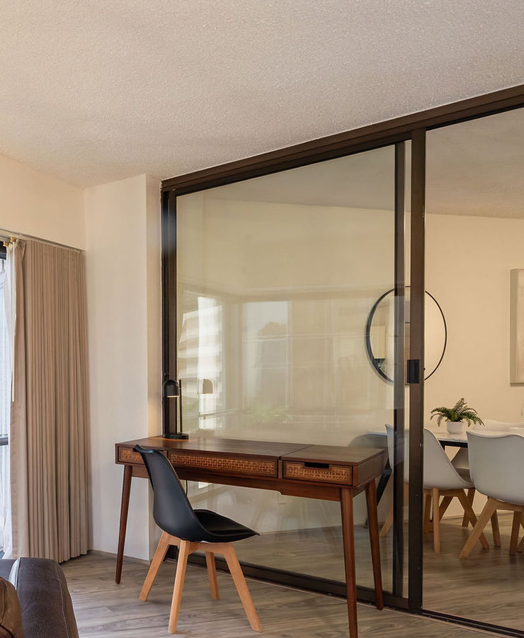 Desk and chair near a glass door